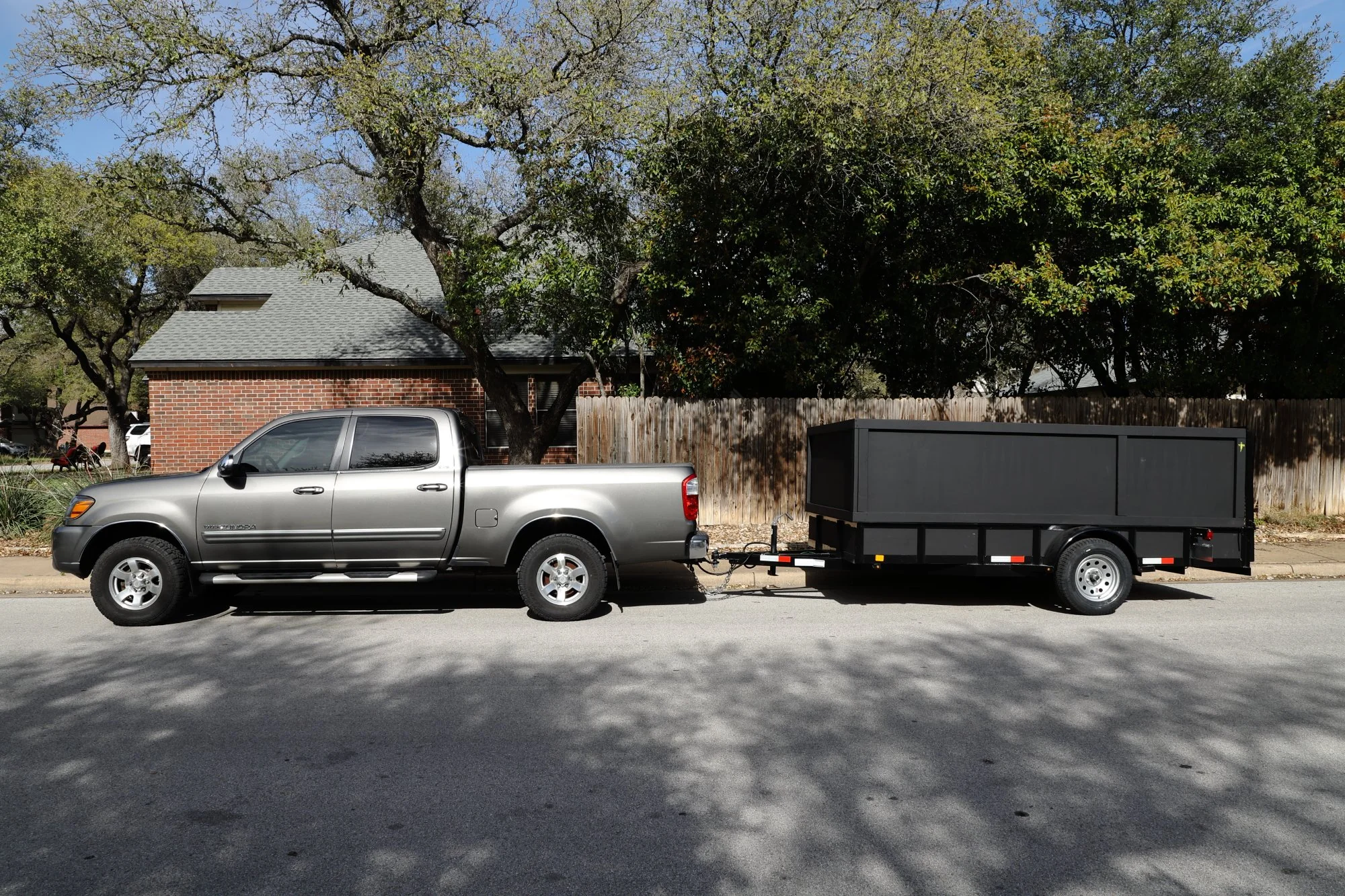 Junk removal truck and trailer serving Leander TX