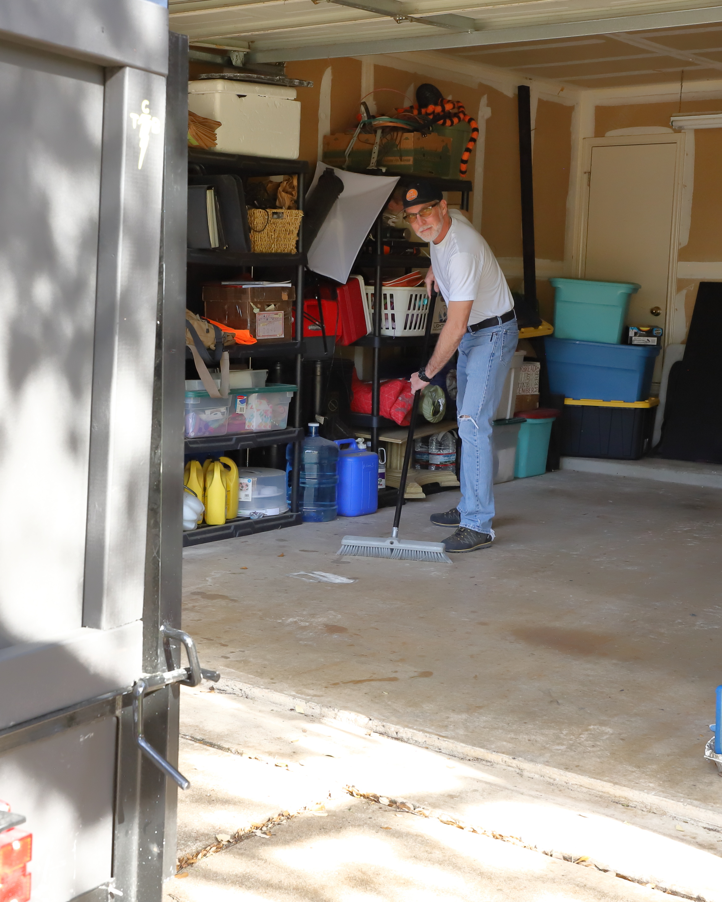 Sean sweeping garage in Brushy Creek area
